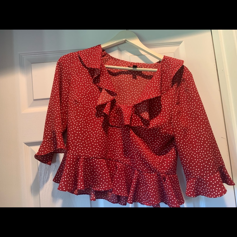 Red polka dot ruffle blouse. Tight if large bust